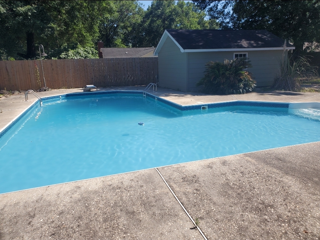 The same vinyl liner pool clear and blue after algae removal