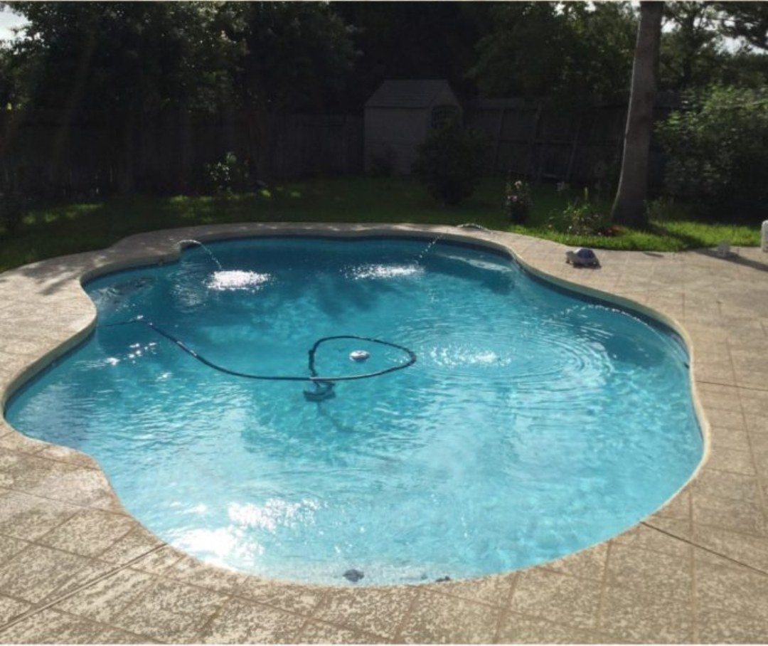 The same freeform pool clear and blue after algae removal